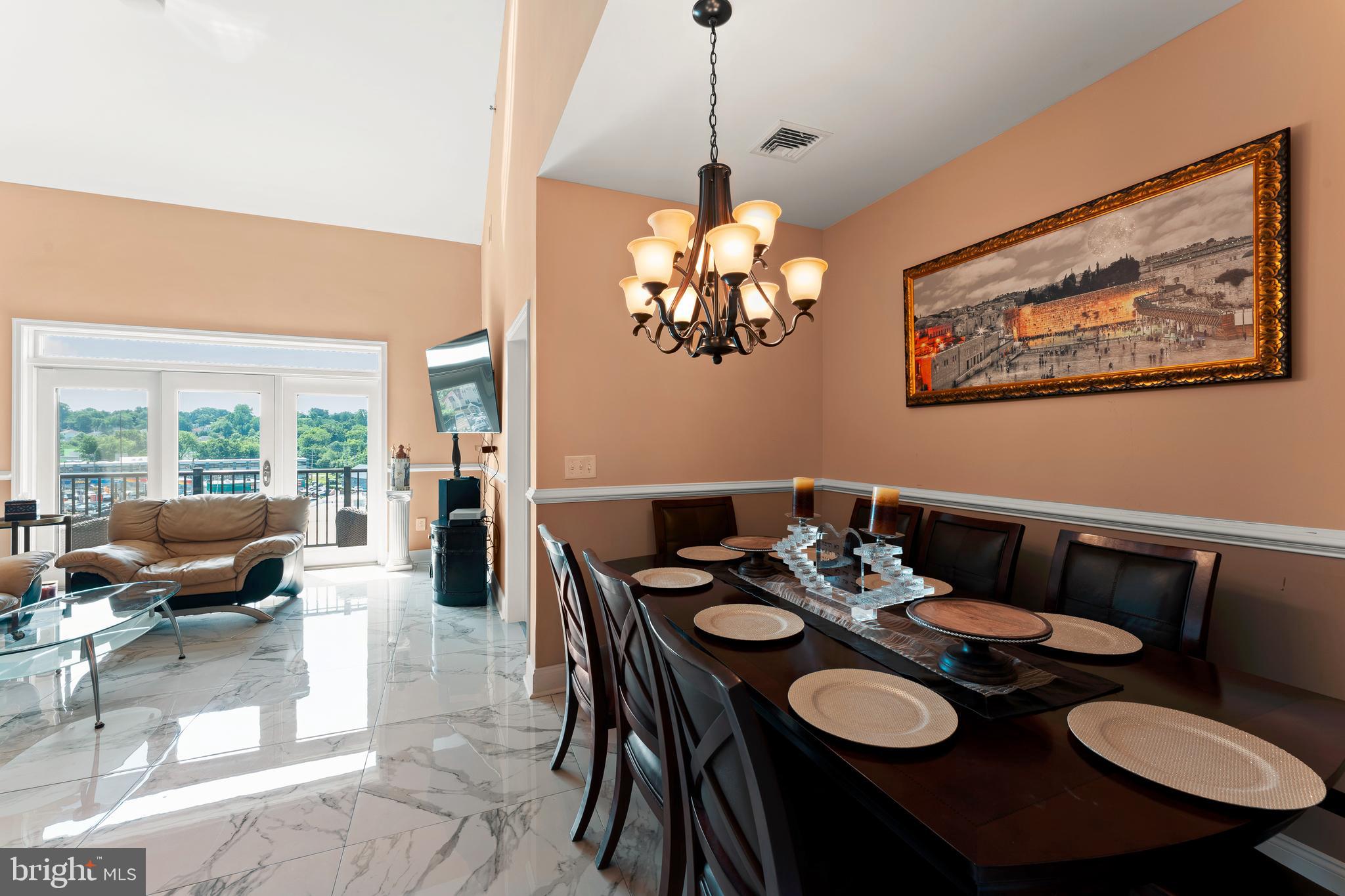 516 Carson Terrace Huntingdon Valley, PA 19006 - Photo 7 of 29 a view of a dining room with furniture wooden floor and a chandelier