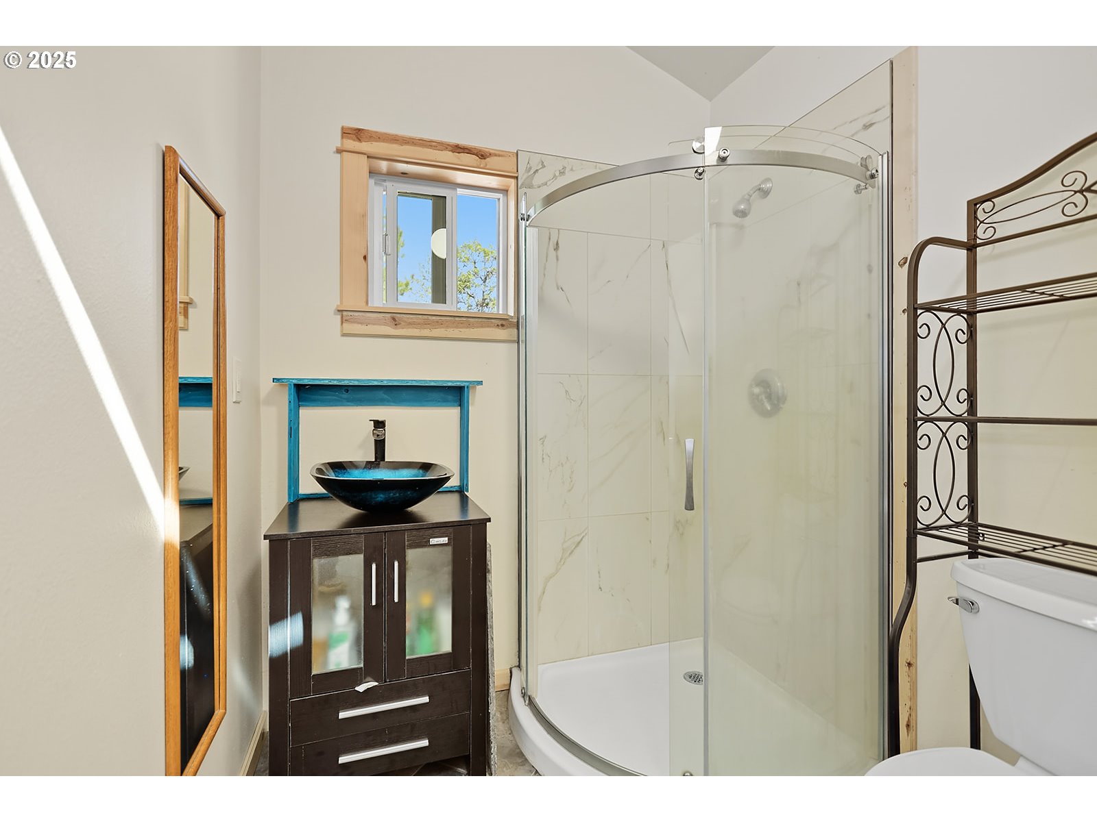 27 Whispering Pines Goldendale, WA 98620 - Photo 23 of 41 a bathroom with a sink a mirror a vanity and shower