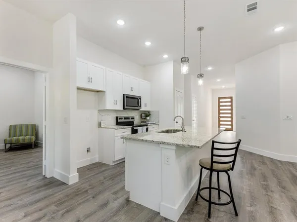 a kitchen with refrigerator and cabinets