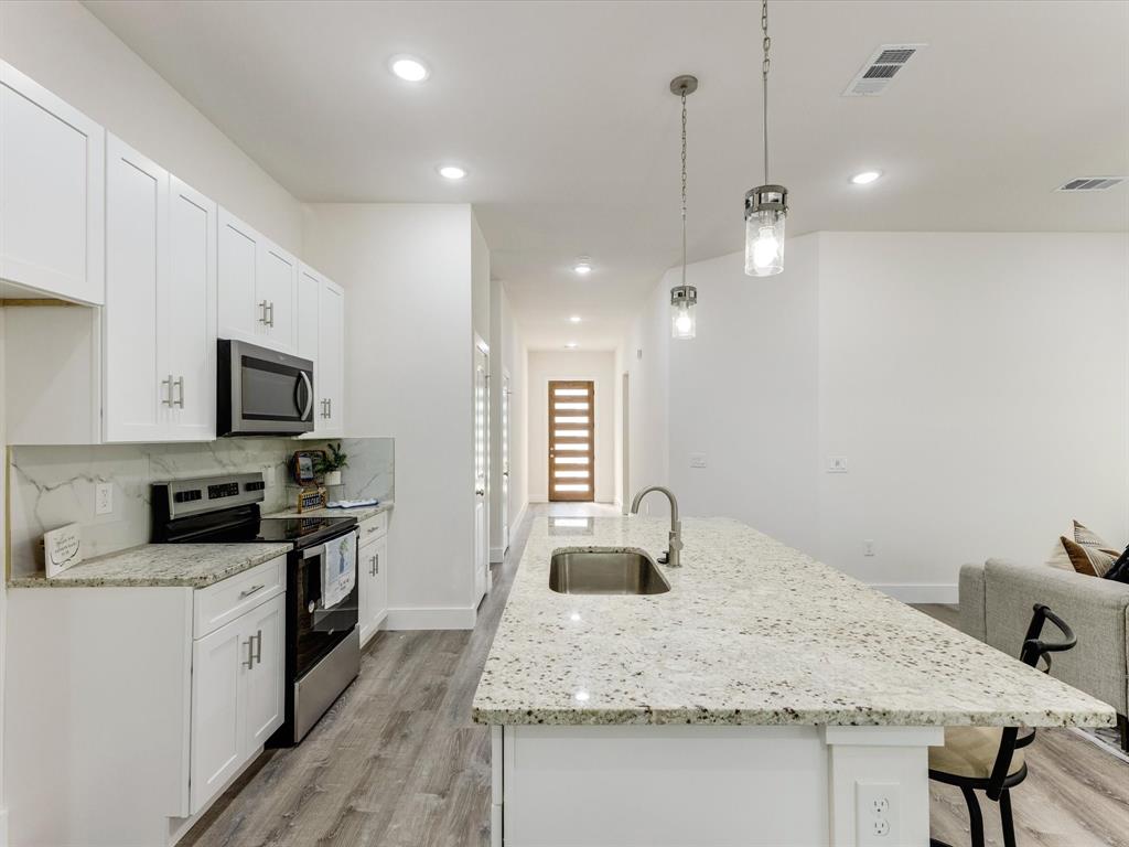 6123 Inca Drive Mabank, TX 75156 - Photo 14 of 31 a kitchen with kitchen island a sink stainless steel appliances and white cabinets