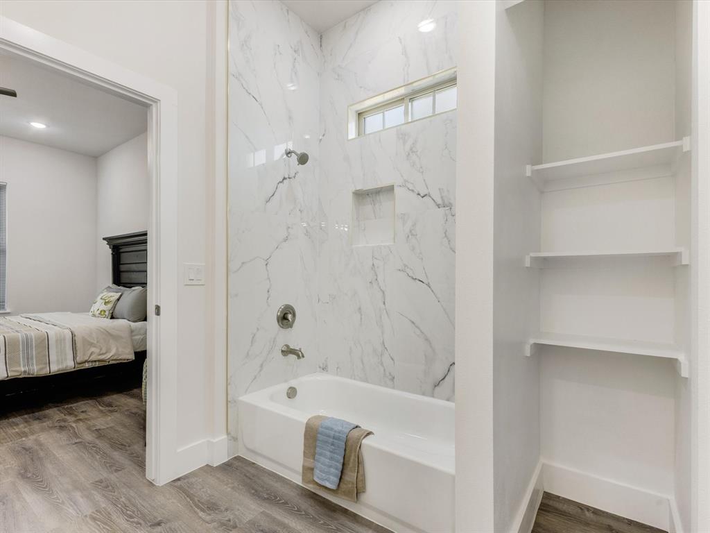 6123 Inca Drive Mabank, TX 75156 - Photo 22 of 31 a bathroom with a tub and shower