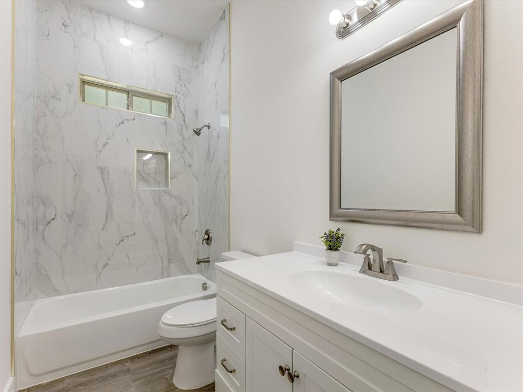 6123 Inca Drive Mabank, TX 75156 - Photo 6 of 31 a bathroom with a bathtub shower sink vanity mirror and toilet