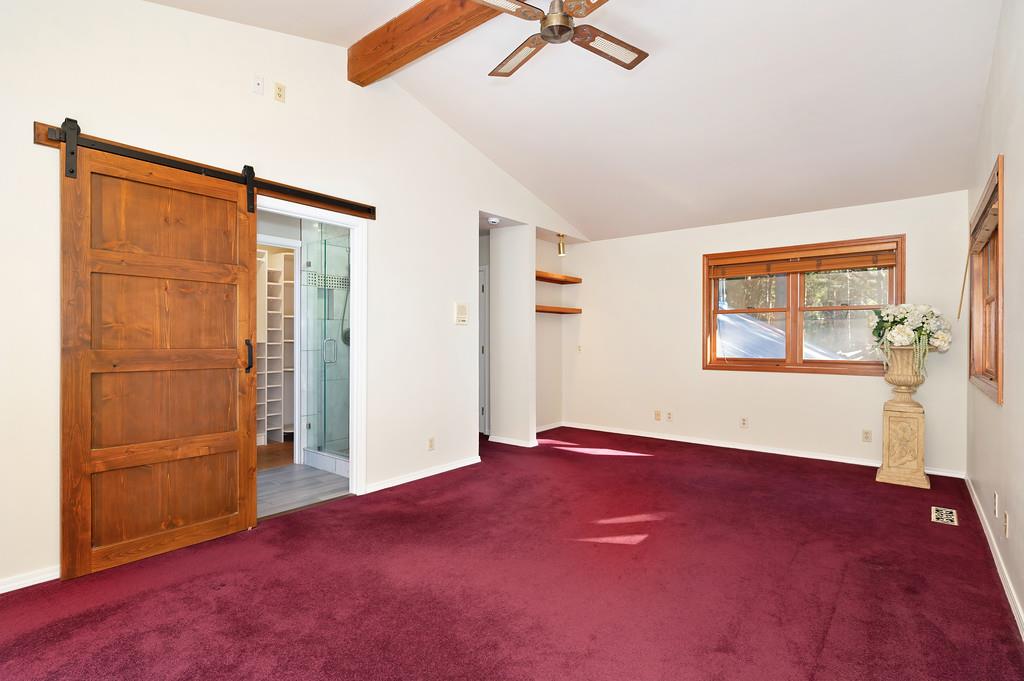 575 Frost Hill Road Alta, CA 95701 - Photo 27 of 82 Master Bedroom: Looking towards the remodeled master bathroom with the custom barn slider door, 1 of 2 closets and seperate shower. This area near the windows is the sitting area enhanced with book shelves.