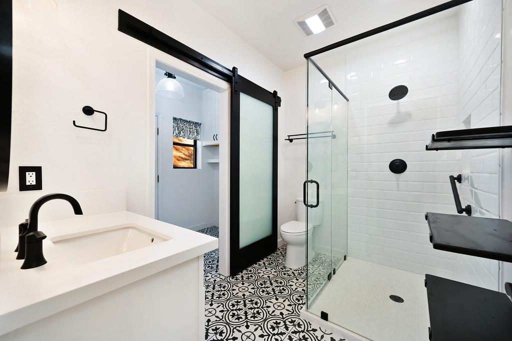 575 Frost Hill Road Alta, CA 95701 - Photo 36 of 82 Viewing the remodeled bathroom on level one and behind the new farm door you see the remodeled laundry room.