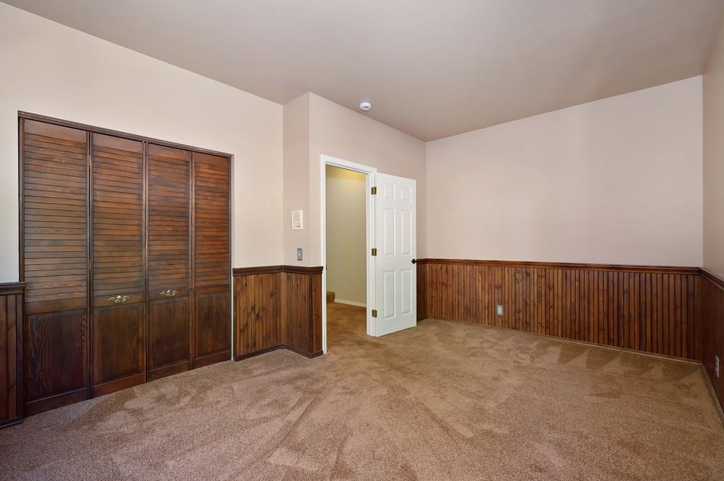 575 Frost Hill Road Alta, CA 95701 - Photo 40 of 82 Bedroom #4 level #1 Enhanced with Wainscoting around the whole room. This is a very private room that has its on floor. Nearby is the remodeled bathroom and the exit to the garage area.