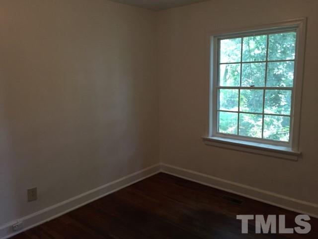 216 Colleton Road Raleigh, NC 27610 - Photo 2 of 11 an empty room with a window
