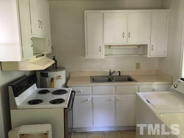 216 Colleton Road Raleigh, NC 27610 - Photo 5 of 11 a kitchen with a sink a stove and cabinets