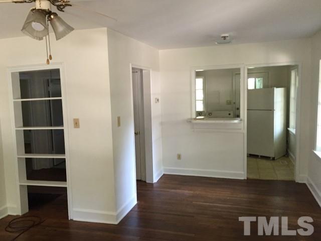 216 Colleton Road Raleigh, NC 27610 - Photo 7 of 11 a view of empty room with wooden floor and cabinet