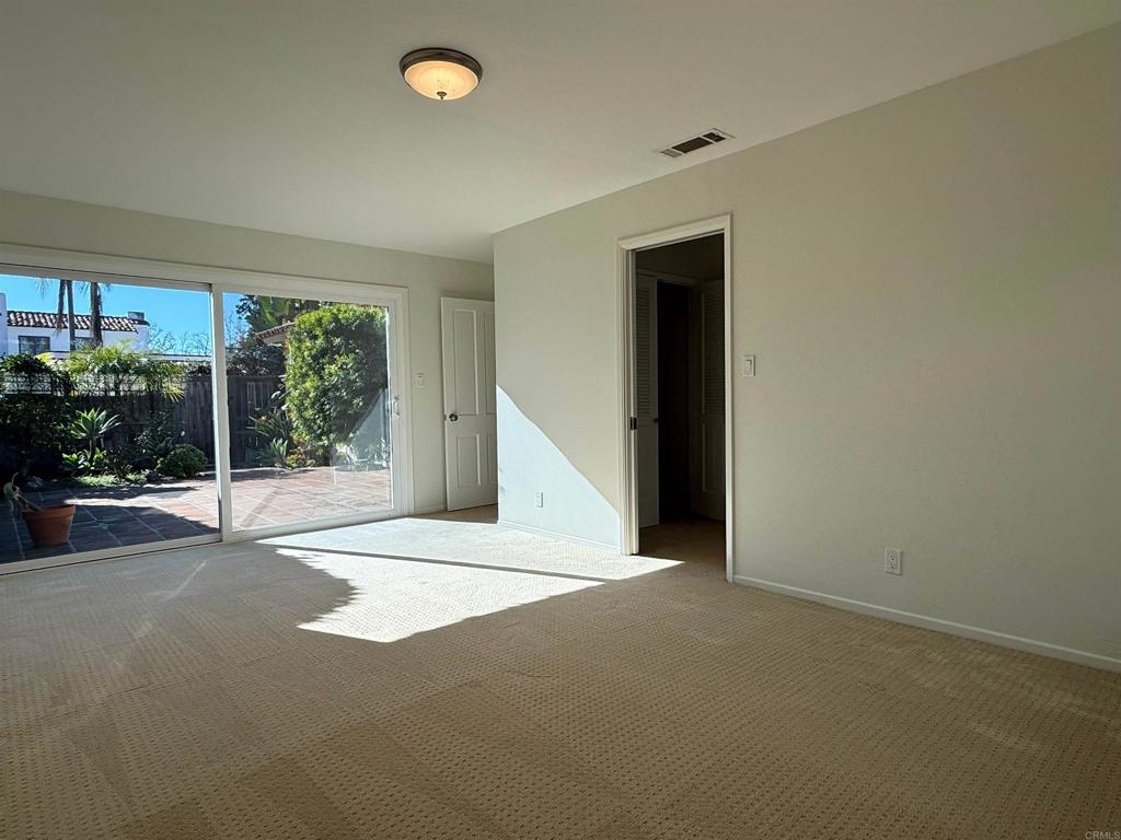 6119 A Paseo Delicias Rancho Santa Fe, CA 92067 - Photo 10 of 14 a view of an empty room with wooden floor and a floor to ceiling window