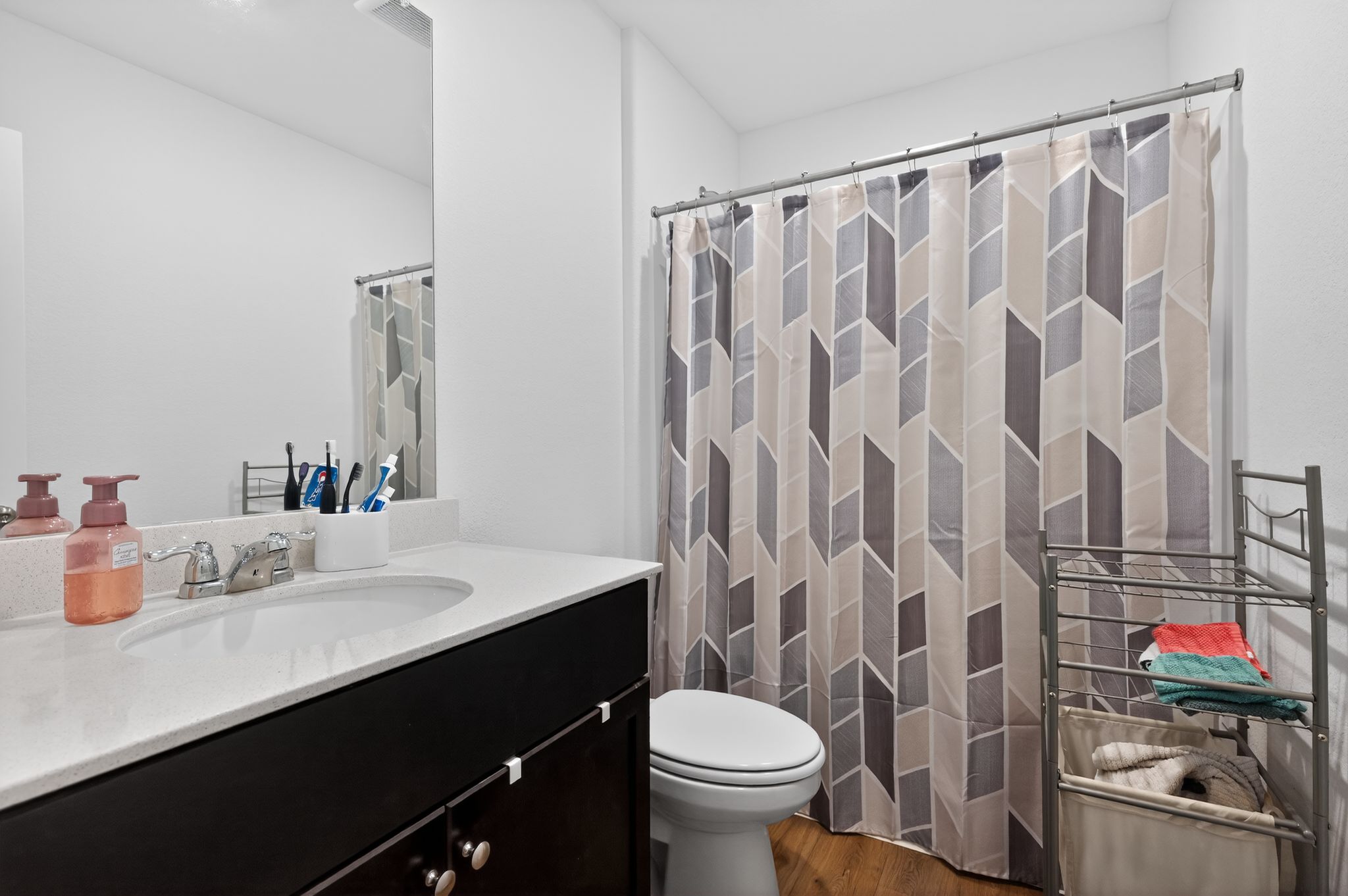 612 Marty Allen Loop Jarrell, TX 76537 - Photo 13 of 15 Bathroom with vanity, a shower with shower curtain, and dark wood-type flooring