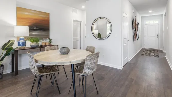 a view of a dining room with furniture and wooden floor