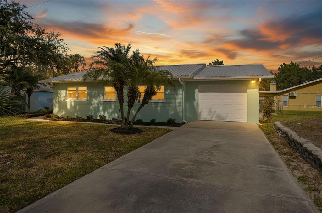 5995 South Shadytree Path Homosassa, FL 34448 - Photo 2 of 64 a front view of a house with a yard and garage
