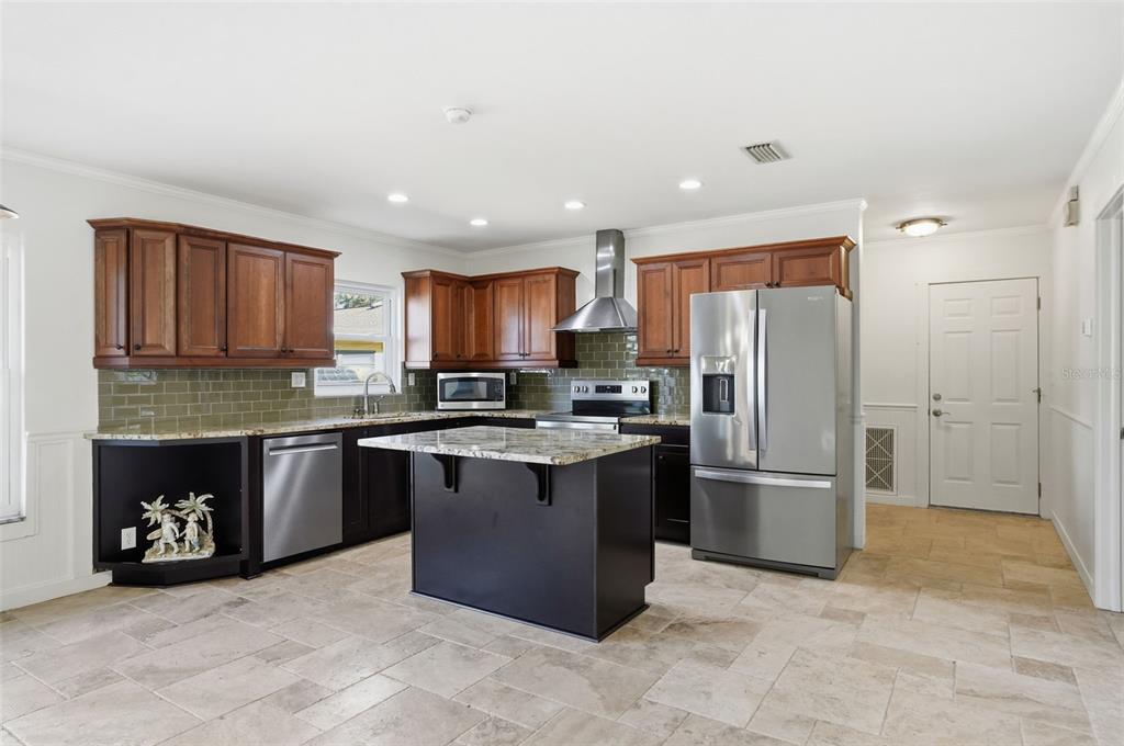 5995 South Shadytree Path Homosassa, FL 34448 - Photo 27 of 64 a kitchen with stainless steel appliances granite countertop a refrigerator and a stove top oven