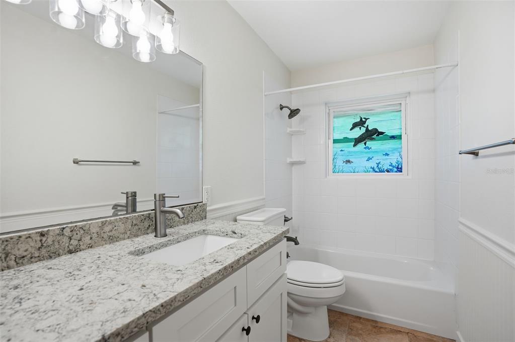 5995 South Shadytree Path Homosassa, FL 34448 - Photo 37 of 64 a bathroom with a granite countertop sink a toilet and a mirror