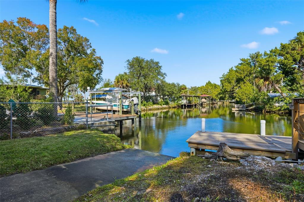 5995 South Shadytree Path Homosassa, FL 34448 - Photo 4 of 64 a view of a lake with lawn chairs