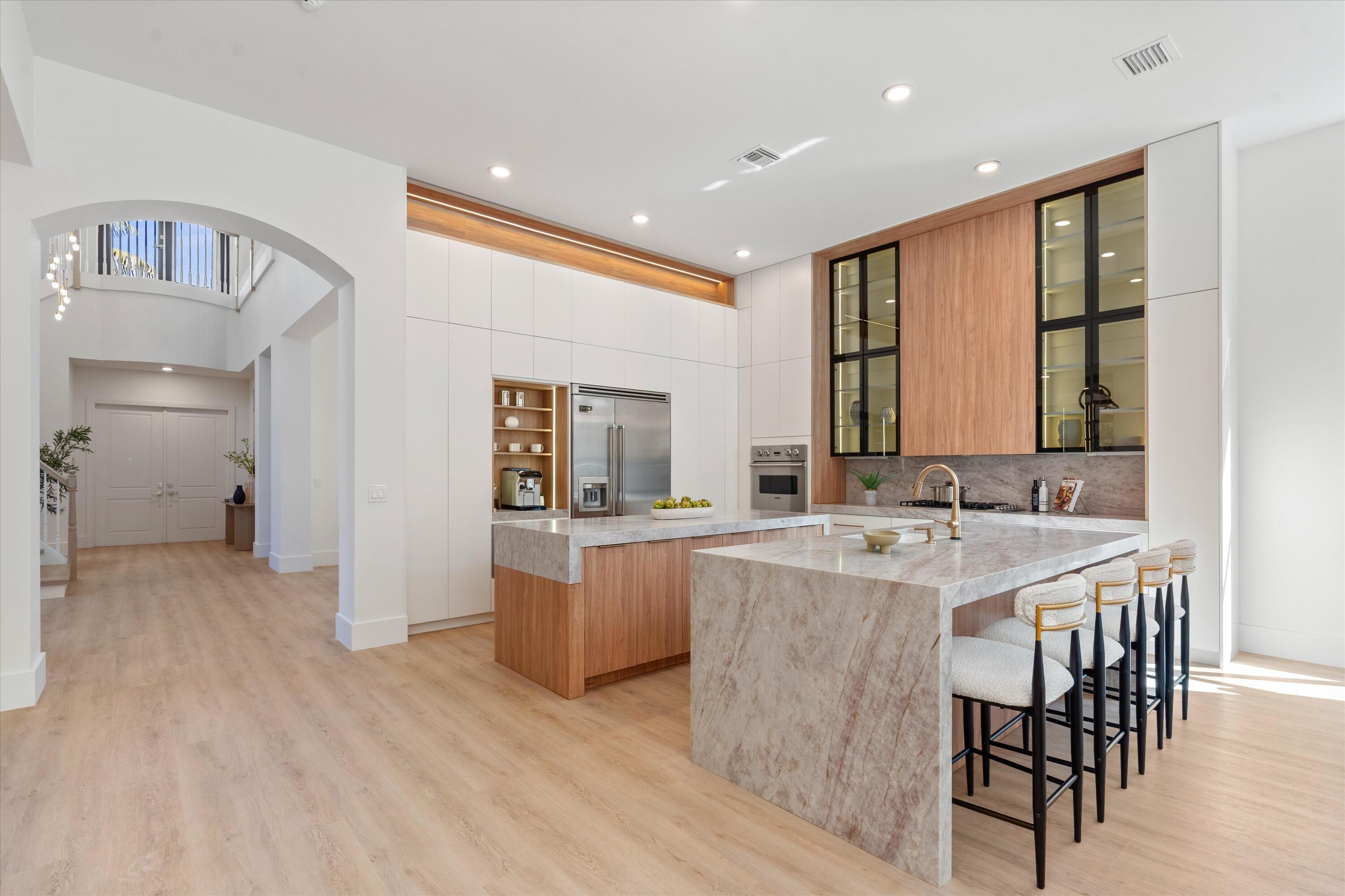 8749 Lewis River Road Delray Beach, FL 33446 - Photo 5 of 32 a large kitchen with a table and chairs in it