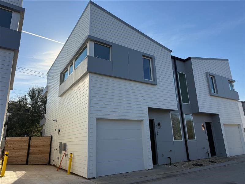 2000 Riverside Farms Road, Unit 8101 Austin, TX 78741 - Photo 1 of 10 Welcome to Riverside Residential, a modern, two-story townhouse with a sleek, white exterior and gray accents. It features a single-car garage and large windows, offering a contemporary design in a compact space.