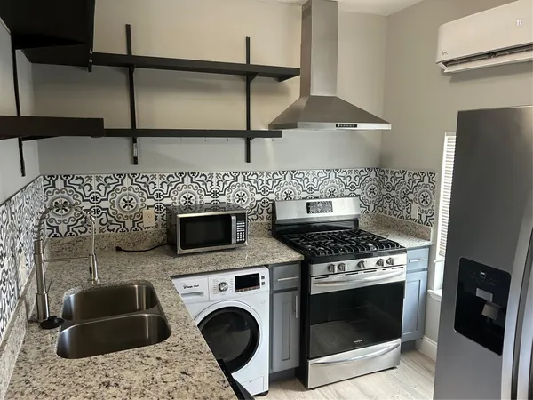 a kitchen with a stove and a microwave