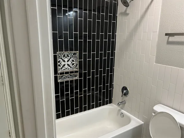 a bathroom with a bathtub and shower