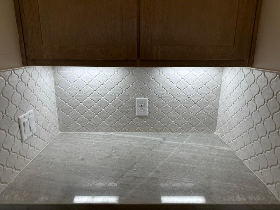 205 Cobb Road Leonard, TX 75452 - Photo 13 of 23 Countertop with a light-colored, patterned tile backsplash and under-cabinet lighting