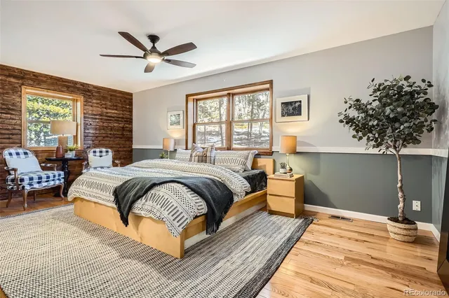 a spacious bedroom with a large bed and a chandelier