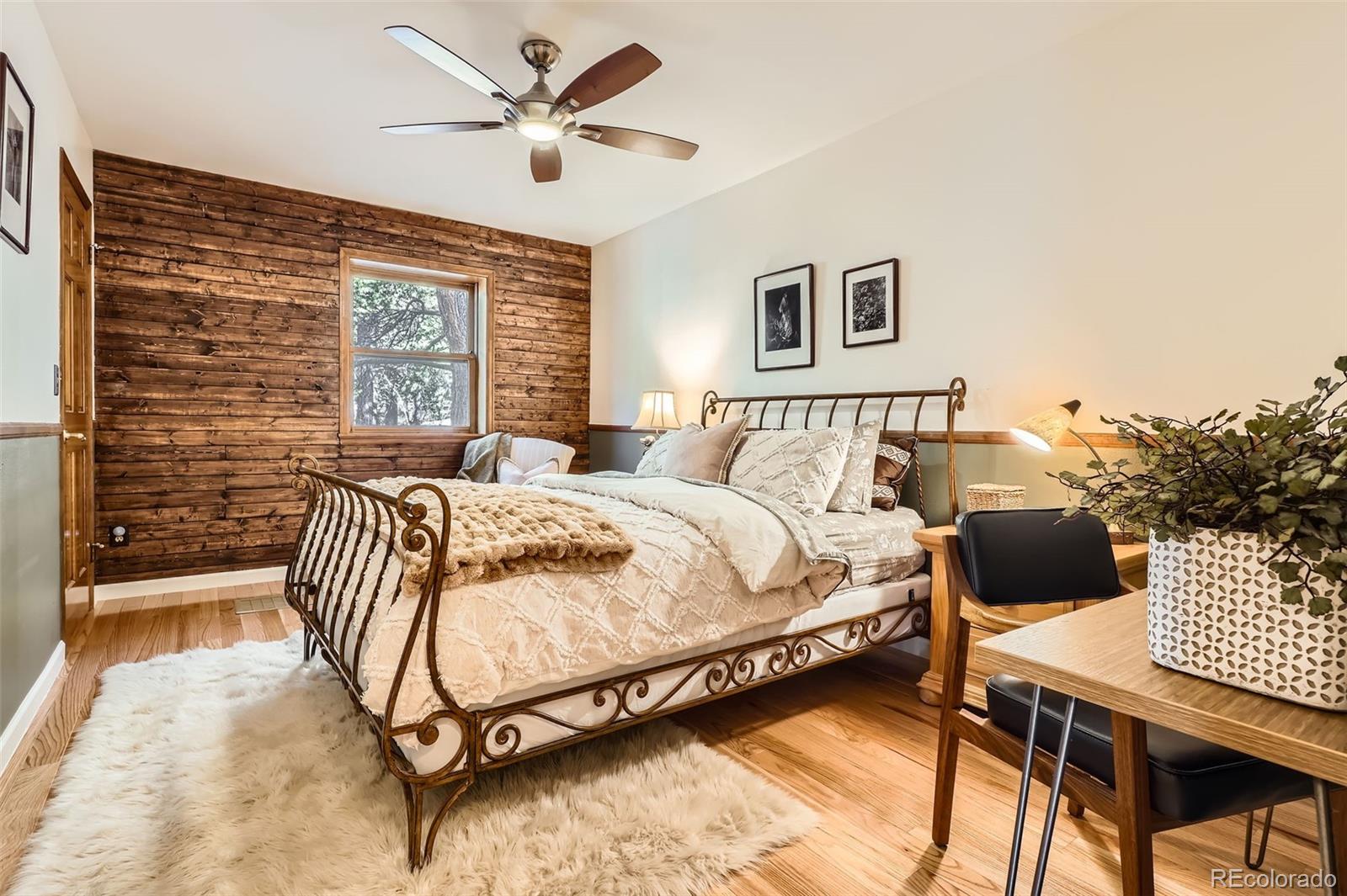 10439 Christopher Drive Conifer, CO 80433 - Photo 15 of 32 a bedroom with a bed and a desk