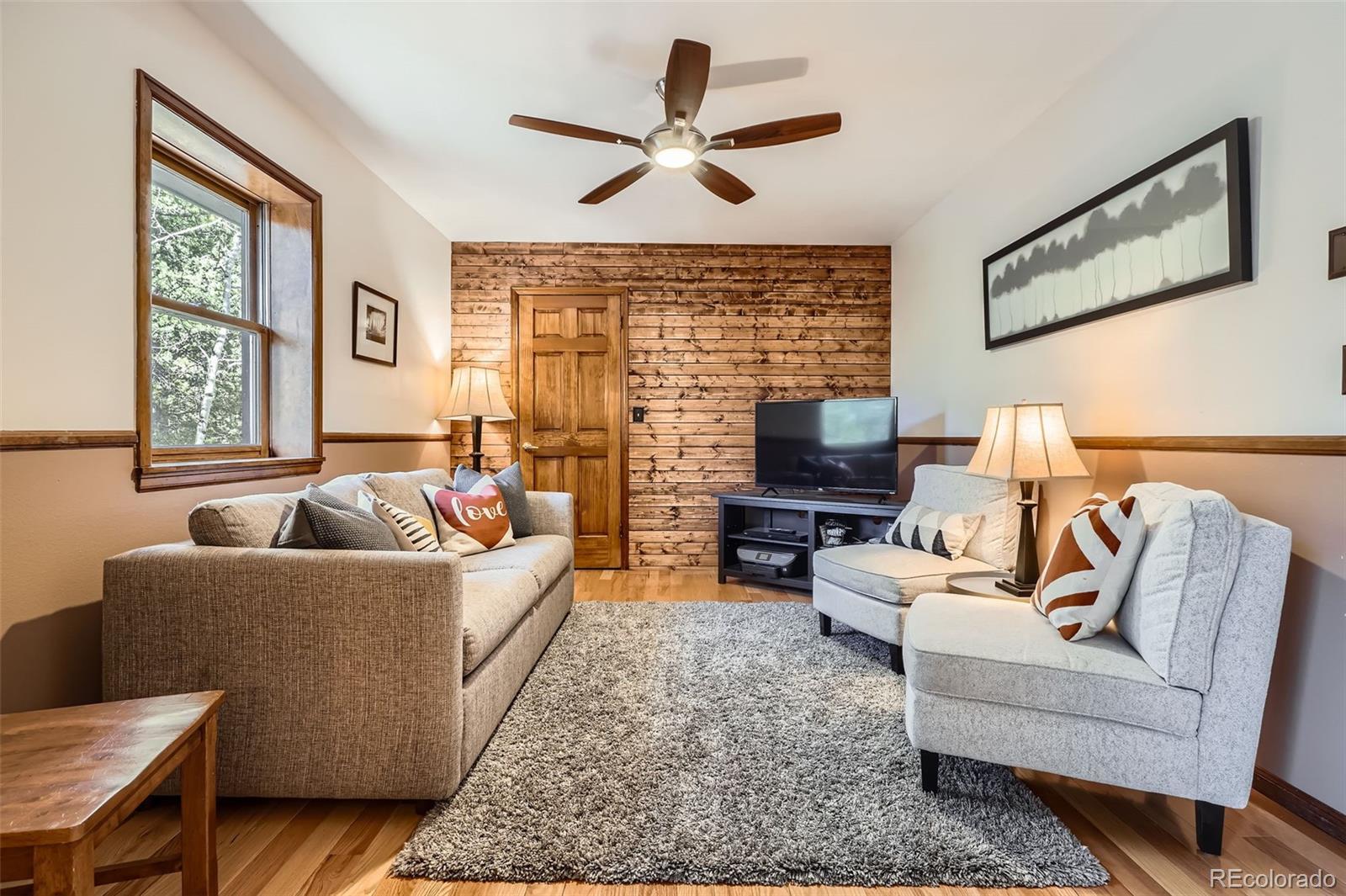 10439 Christopher Drive Conifer, CO 80433 - Photo 25 of 32 a living room with furniture and a large window