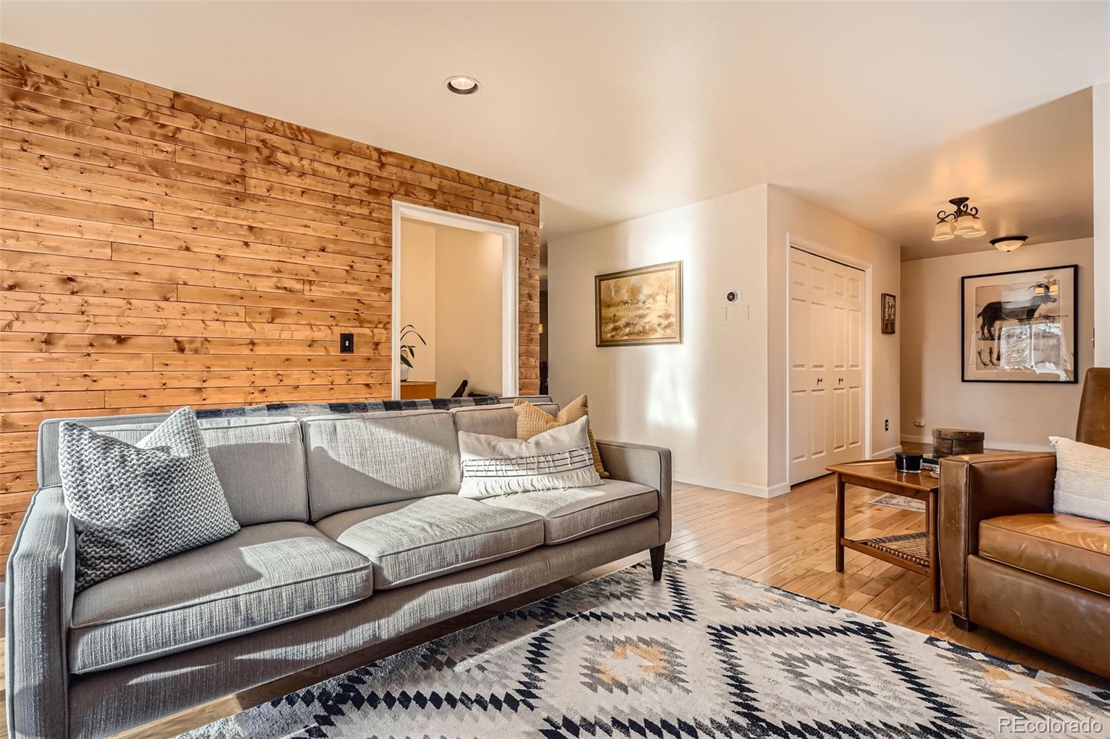 10439 Christopher Drive Conifer, CO 80433 - Photo 6 of 32 a living room with furniture and painting on the wall