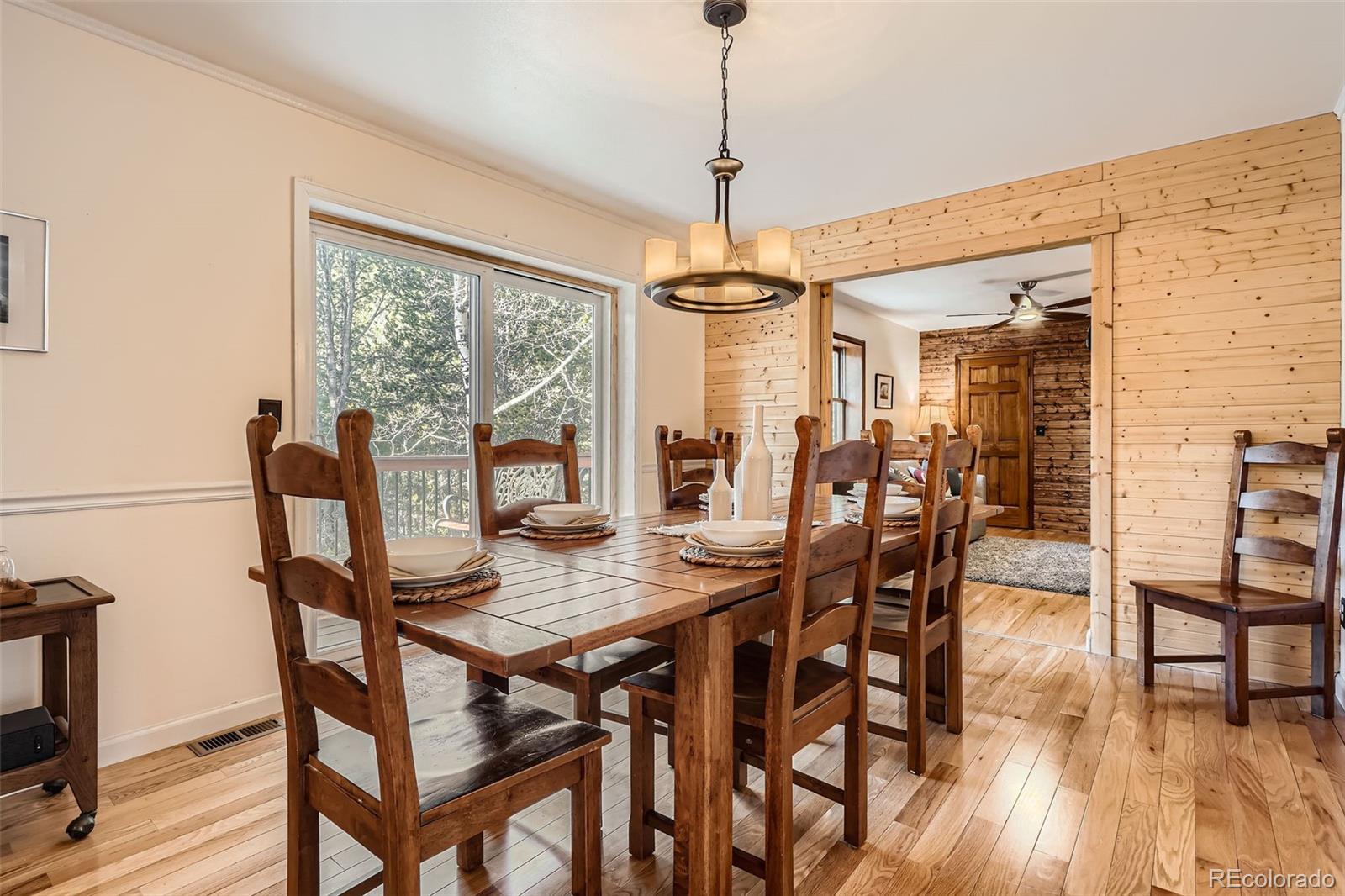 10439 Christopher Drive Conifer, CO 80433 - Photo 7 of 32 a view of a dining room with furniture window and wooden floor