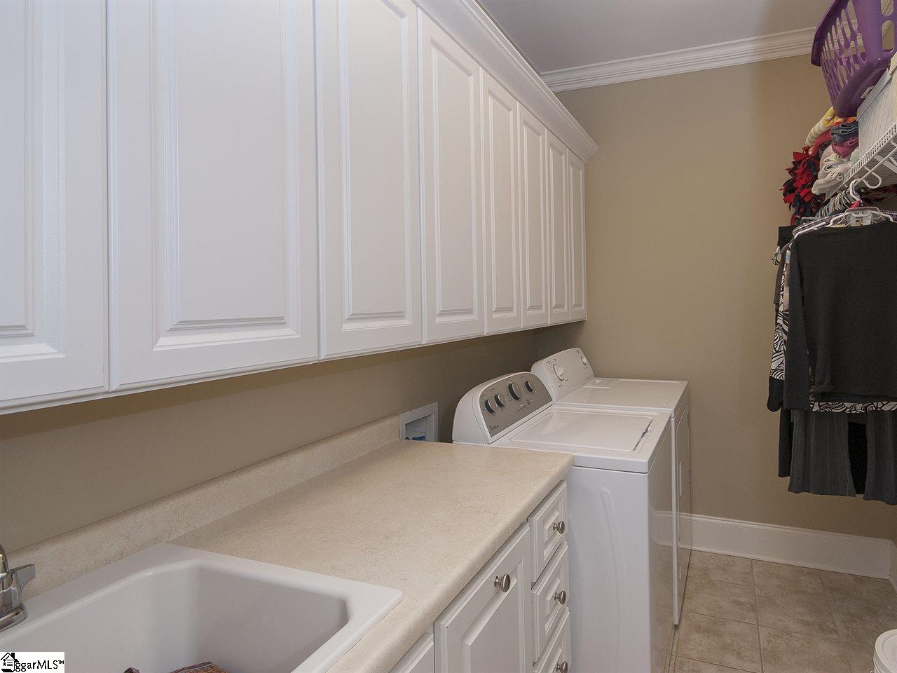 66 Sycamore Ridge Drive Simpsonville, SC 29681 - Photo 22 of 36 Sink, cabinets and hanging rack