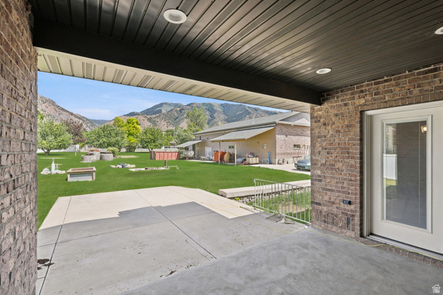 580 North 300 East Logan, UT 84321 - Photo 57 of 74 Covered patio with recessed lighting, brick exterior, and direct access to a large grass area