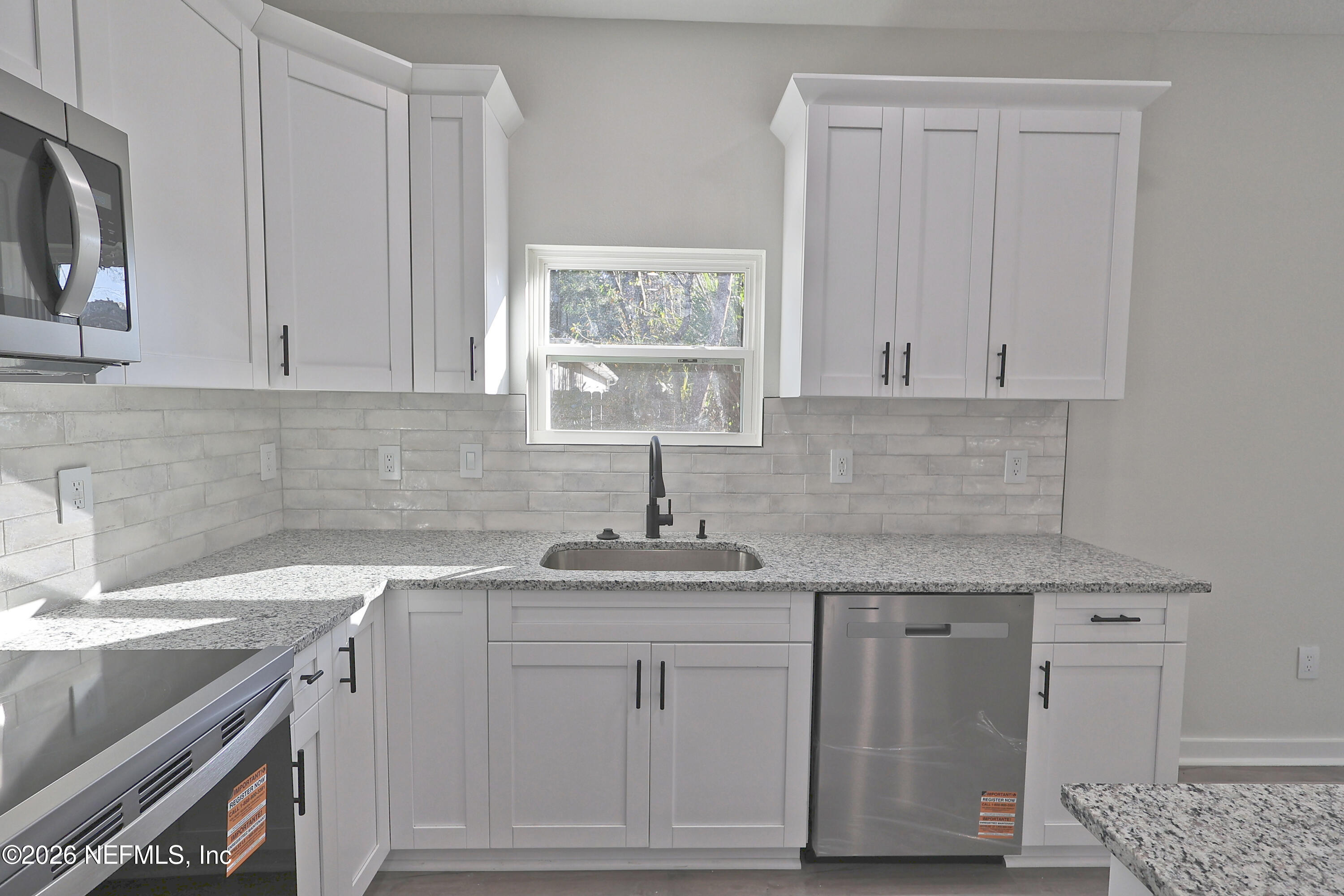 30 Delmonte Street Baldwin, FL 32234 - Photo 9 of 37 a kitchen with a sink cabinets and window