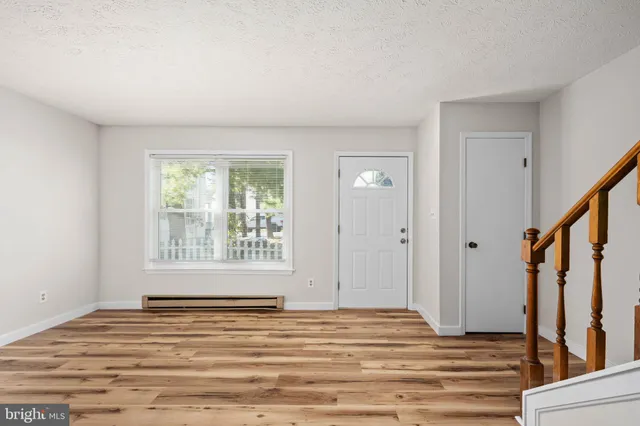 a kitchen with cabinets stainless steel appliances a sink and a window
