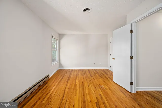 a kitchen with white cabinets and black appliances