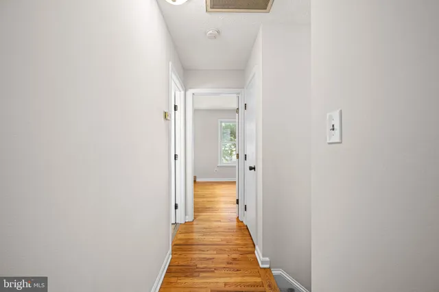 a view of a room with wooden floor and small space