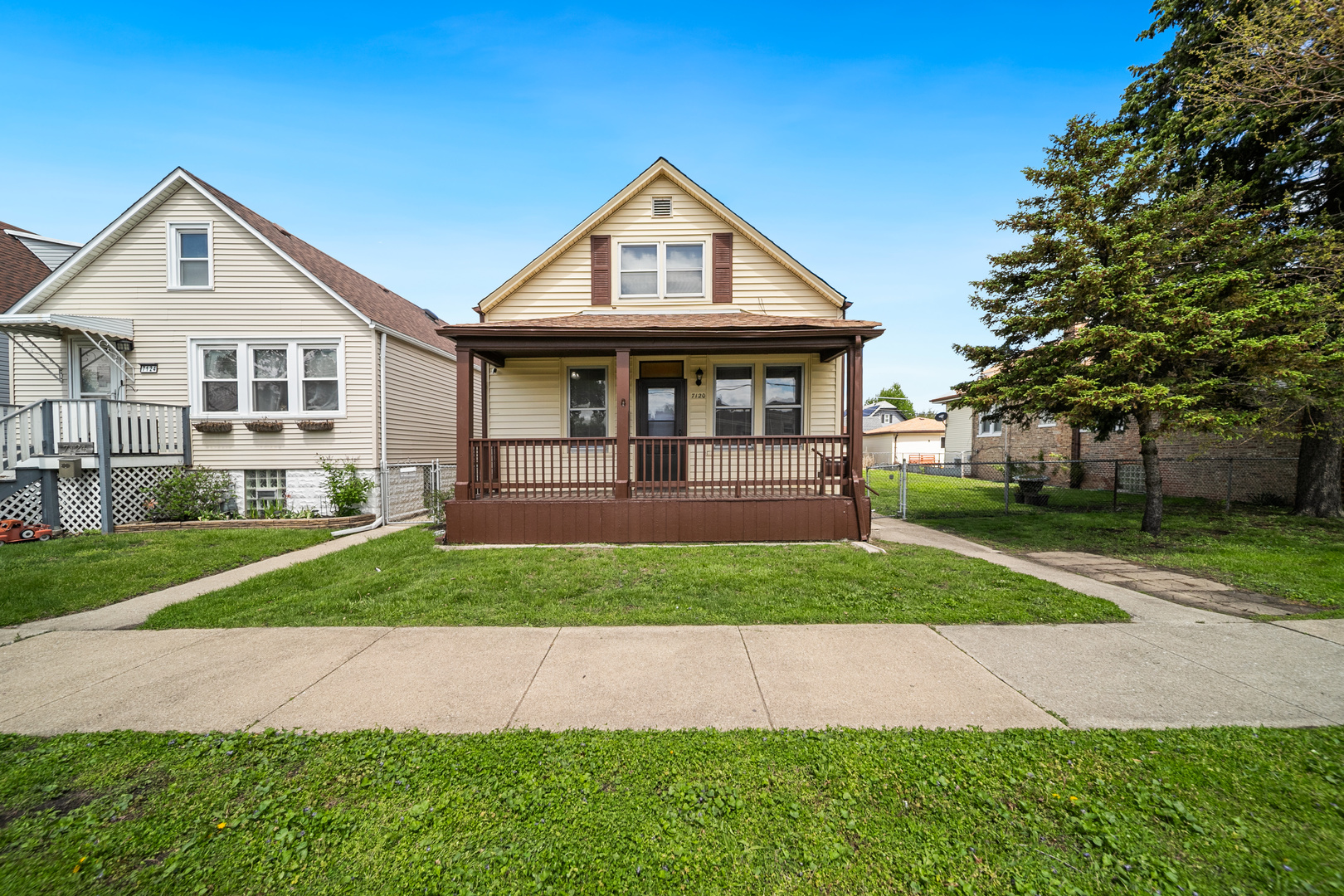 7120 41st Street Stickney, IL 60402 - Photo 1 of 13 a front view of a house with a yard and trees