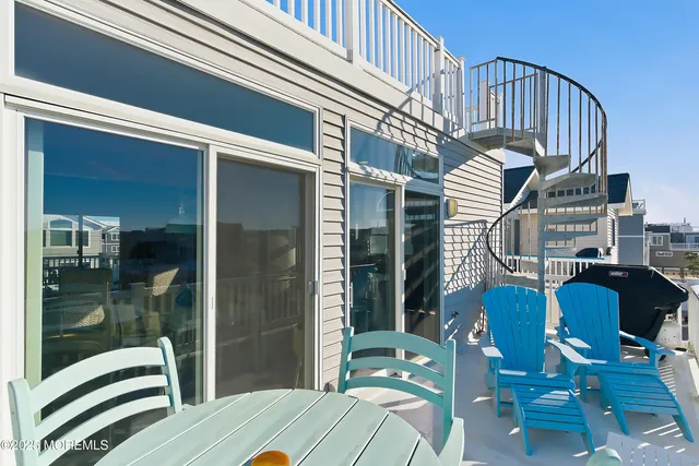 a view of a balcony with table and chairs