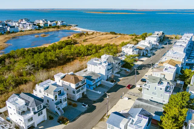 an aerial view of a house with a ocean view