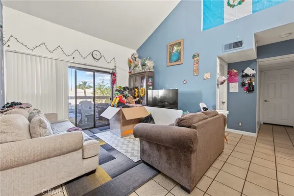 a living room with furniture and a floor to ceiling window