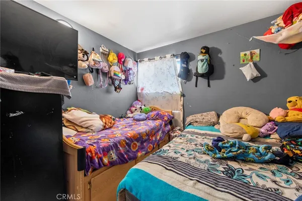a bedroom with two beds and a painting on the wall
