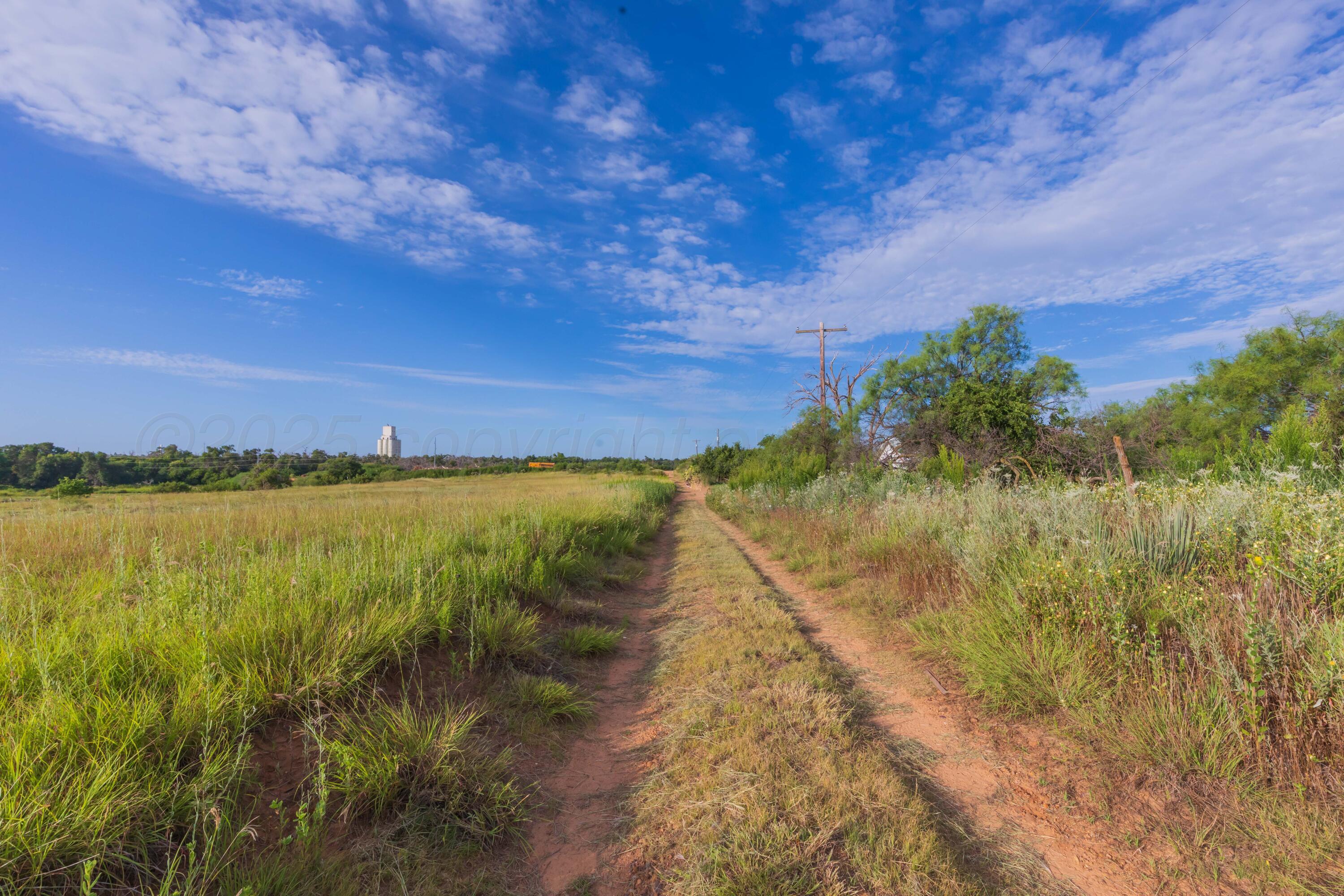 501 North Koogle Street Clarendon, TX 79226 - Photo 18 of 27 a view of a lake with a yard