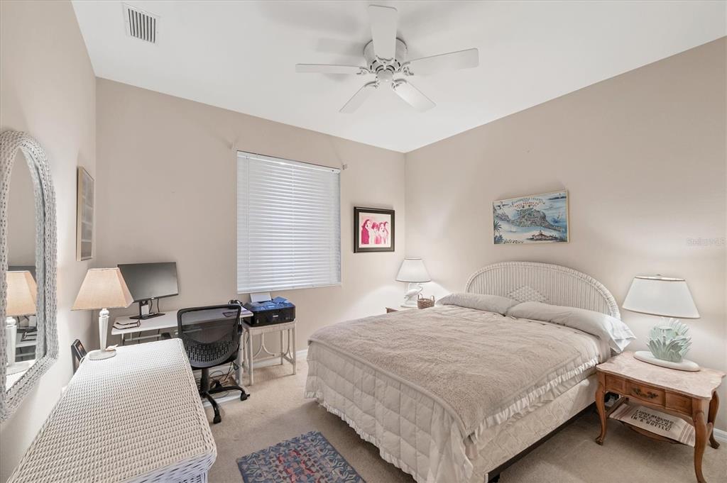 4 Windward Way Placida, FL 33946 - Photo 29 of 39 a bedroom with a bed and a chandelier