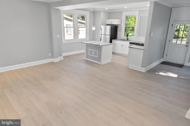 a kitchen with stainless steel appliances granite countertop a stove microwave and cabinets