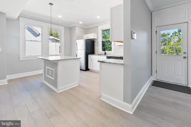 a kitchen with stainless steel appliances granite countertop a sink a stove and microwave