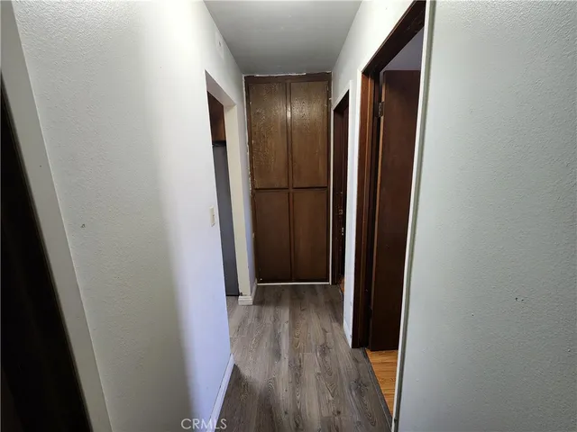 a view of hallway with wooden floor
