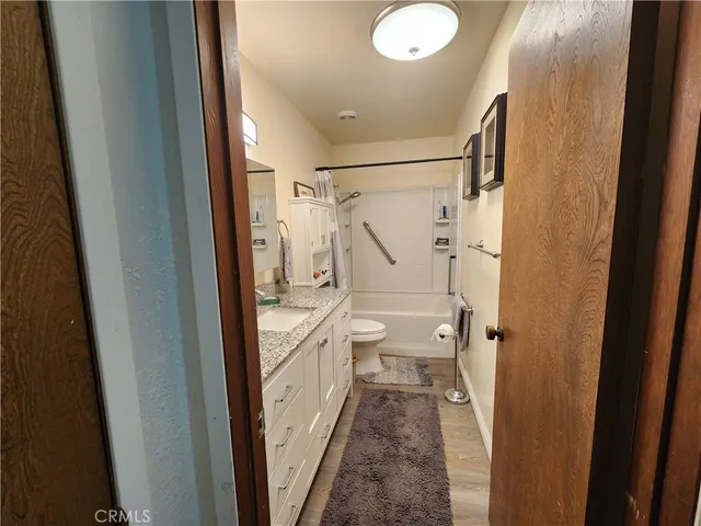a bathroom with a double vanity sink toilet and shower