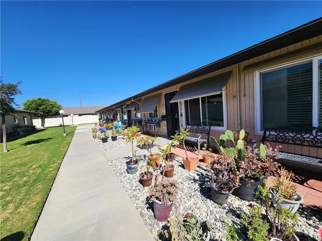 a view of a house with yard and sitting area