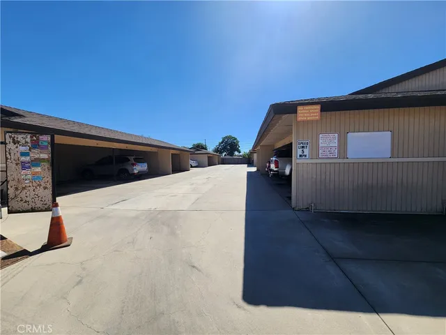 a view of swimming pool with outdoor seating and house in the background