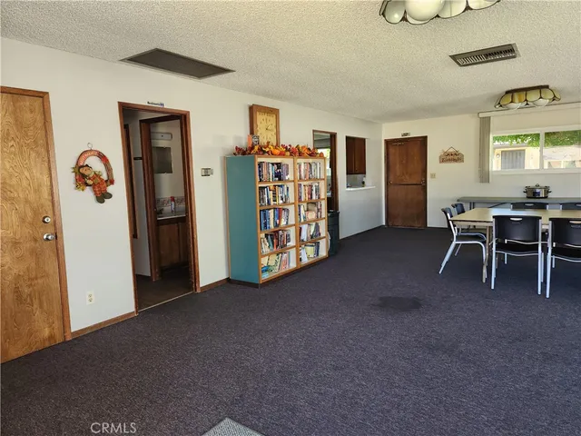 a kitchen with kitchen island granite countertop a sink cabinets and stainless steel appliances