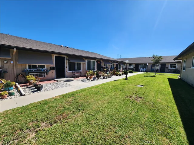 a view of a backyard with a patio and swimming pool